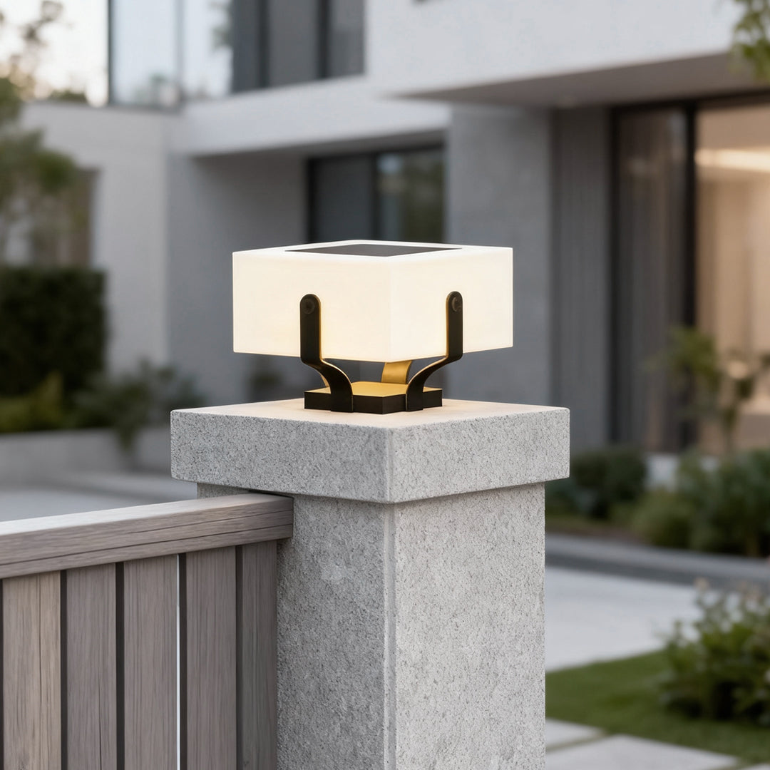 Outdoor brick pillar lights mounted on a stone pillar, providing elegant illumination for a modern driveway.
