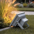 Outdoor flood lights LED illuminating a garden pathway with warm light.