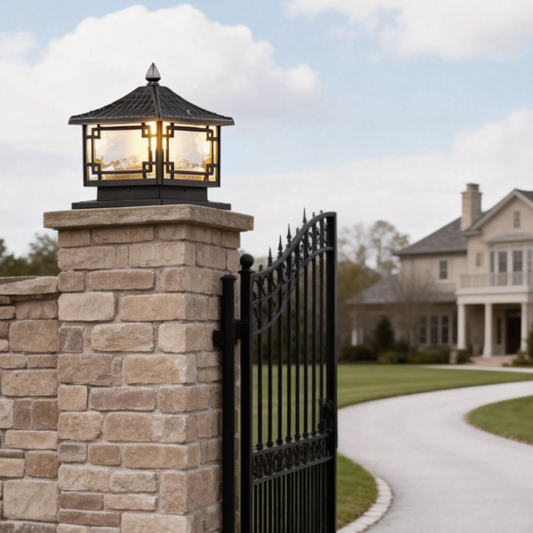 Outdoor garden pillar lights installed at a driveway entrance, providing elegant illumination for a residential gate.