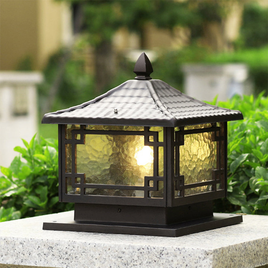 Outdoor garden pillar lights with frosted glass panels, providing gentle light for garden pathways.