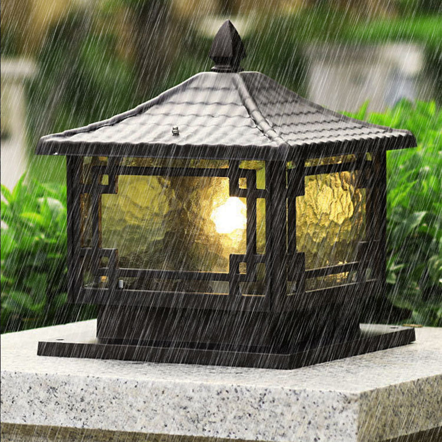 Outdoor garden pillar lights during rainfall, showcasing weather-resistant design and warm illumination.