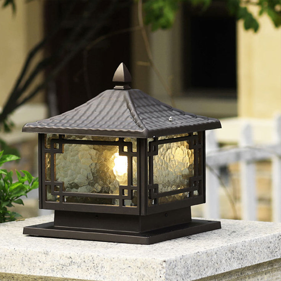 Outdoor garden pillar lights installed along a stone wall, creating a charming and inviting garden ambiance.