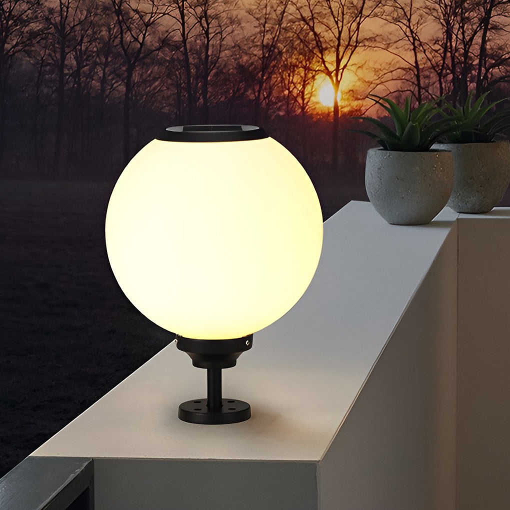 Outdoor gate pillar light with a round shape, casting a soft glow during sunset for a cozy outdoor atmosphere.