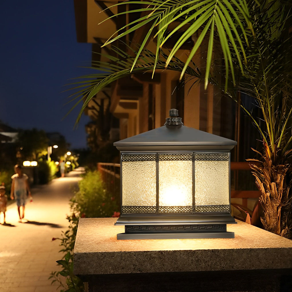 Outdoor gate pillar light providing warm ambient lighting along a residential walkway at night.