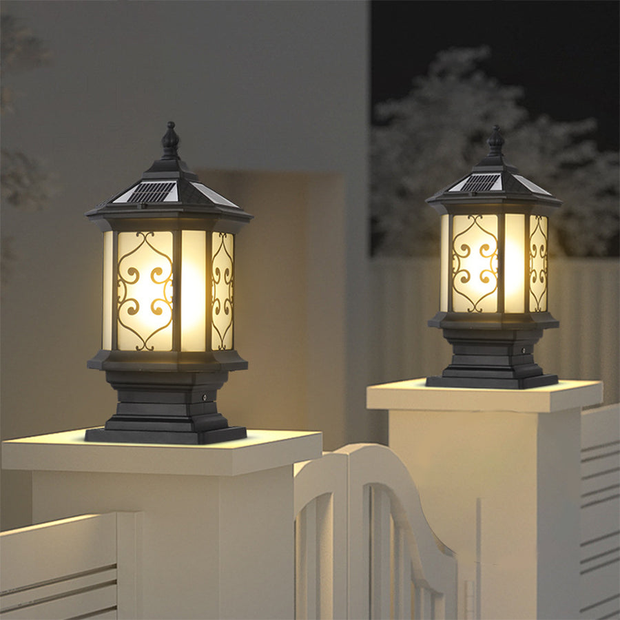 Outdoor gate pillar lights installed along a brick wall, enhancing the pathway with warm illumination.