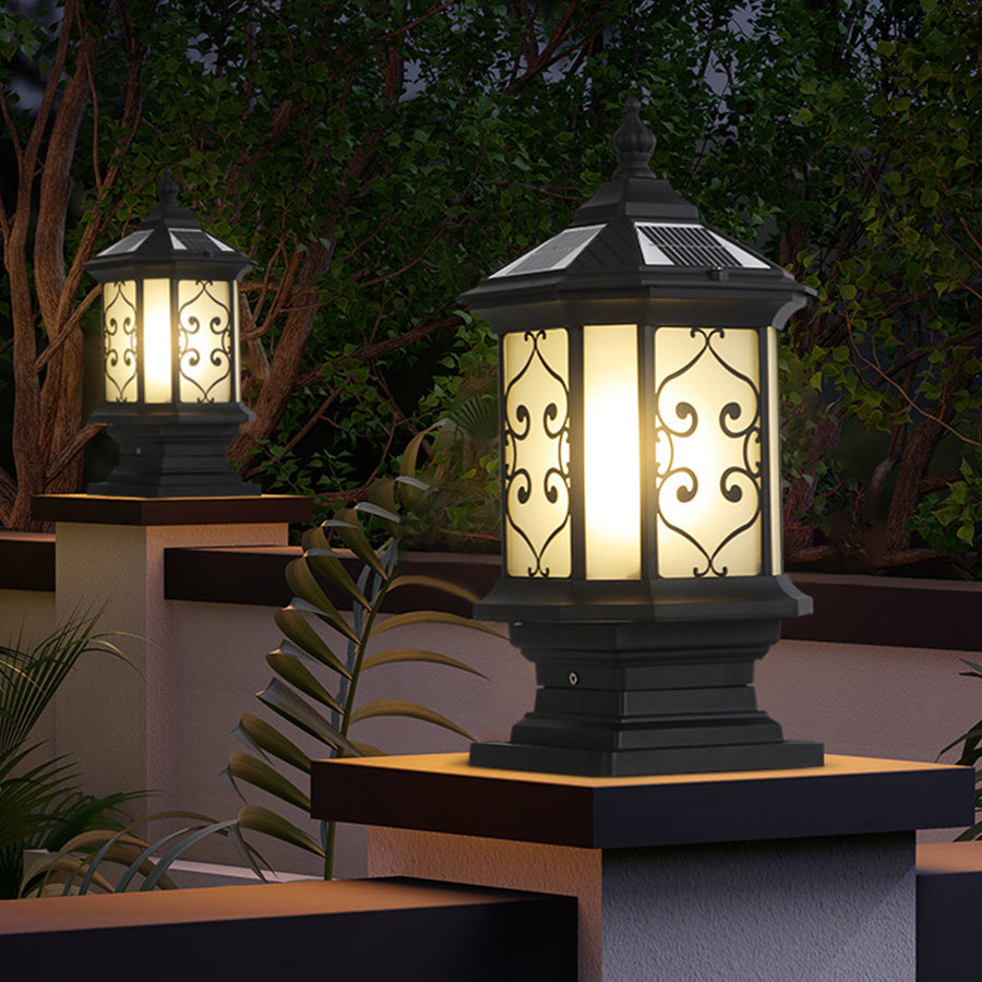 Outdoor gate pillar lights with decorative glass panels, enhancing the ambiance of a garden pathway.