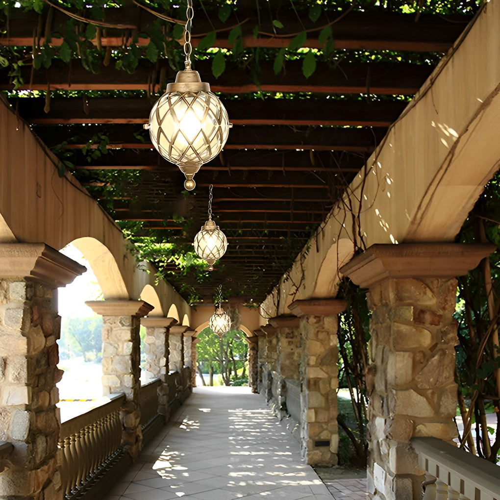 Globe pendant lights installed under a vine-covered walkway creating soft outdoor illumination.
