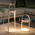Outdoor landscaping lighting lanterns displayed on patio furniture creating warm ambiance.