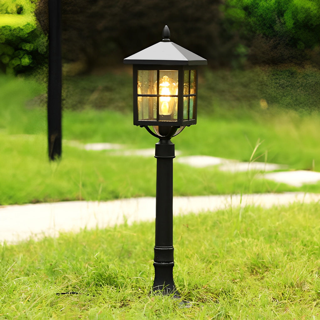 Outdoor lawn lights with a modern design, installed on a grassy lawn near a pathway.