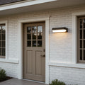 Outdoor lighting wall with a contemporary design, providing warm illumination near a patio.