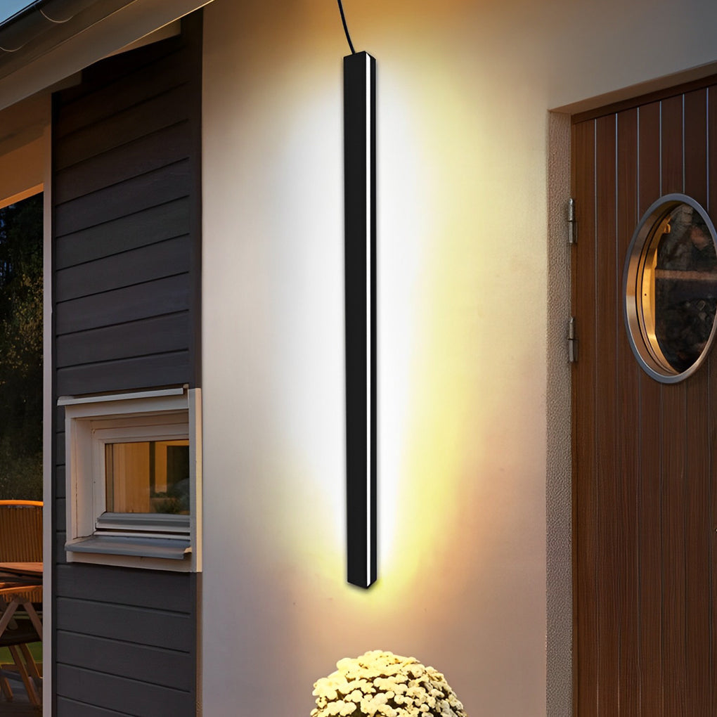 Outdoor linear wall light mounted near entryway door enhancing nighttime visibility and style.