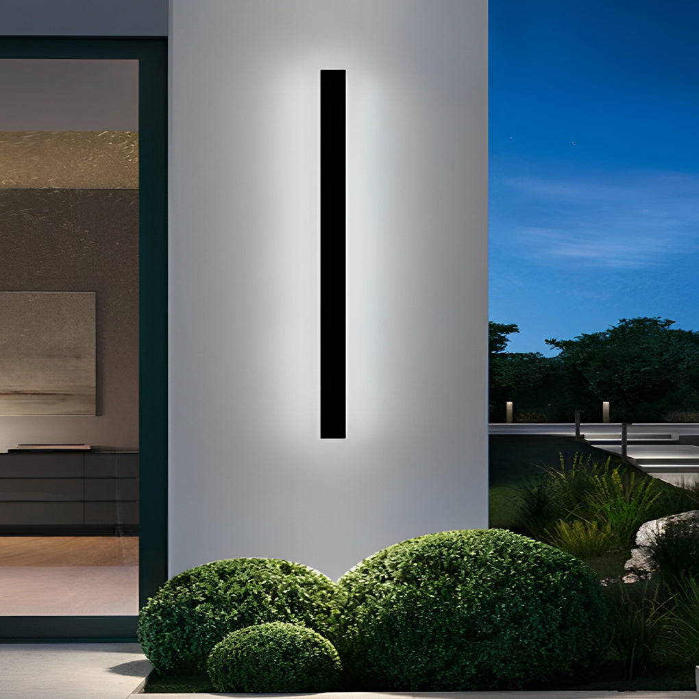 Outdoor linear wall light installed on tall exterior column accenting modern garden architecture.