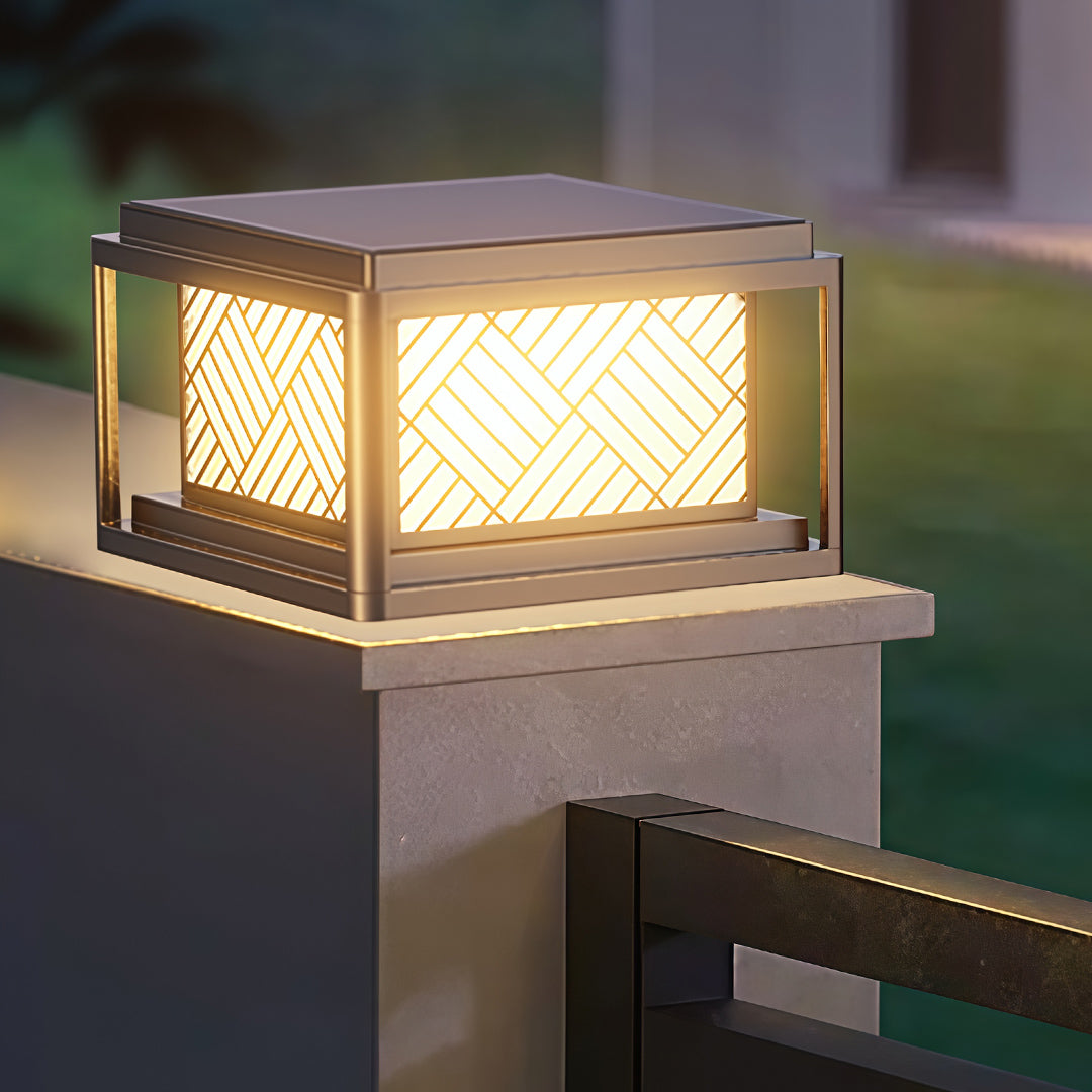 Single outdoor pillar LED light mounted on concrete post near modern home exterior.