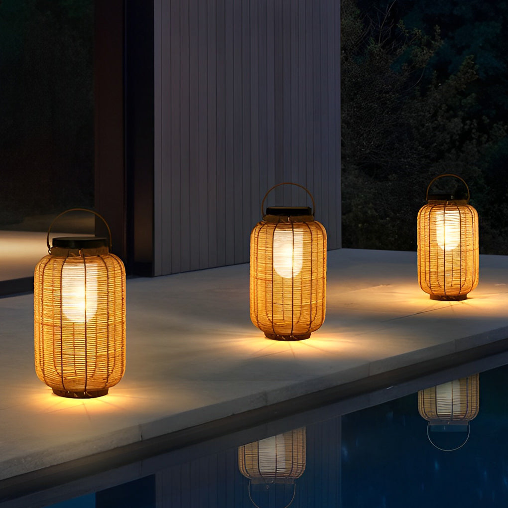 Outdoor rattan lanterns on wooden deck beside pool at night.