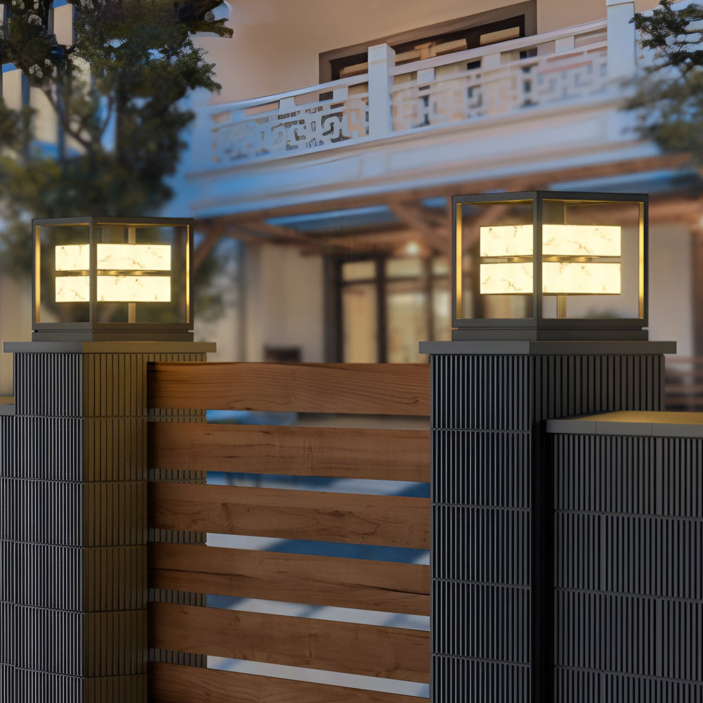 Modern outdoor solar post light beside residential fence