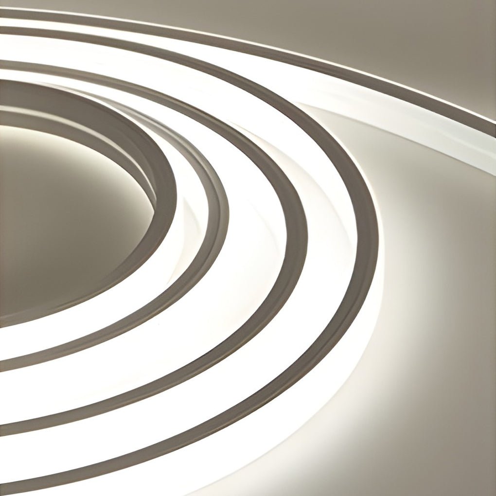 Outdoor stair lighting strips providing directional light along a curved concrete staircase.