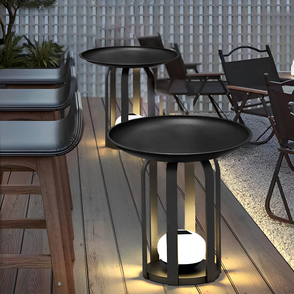 Outdoor tray floor lamp with a round tray top, providing ambient light near a pool.