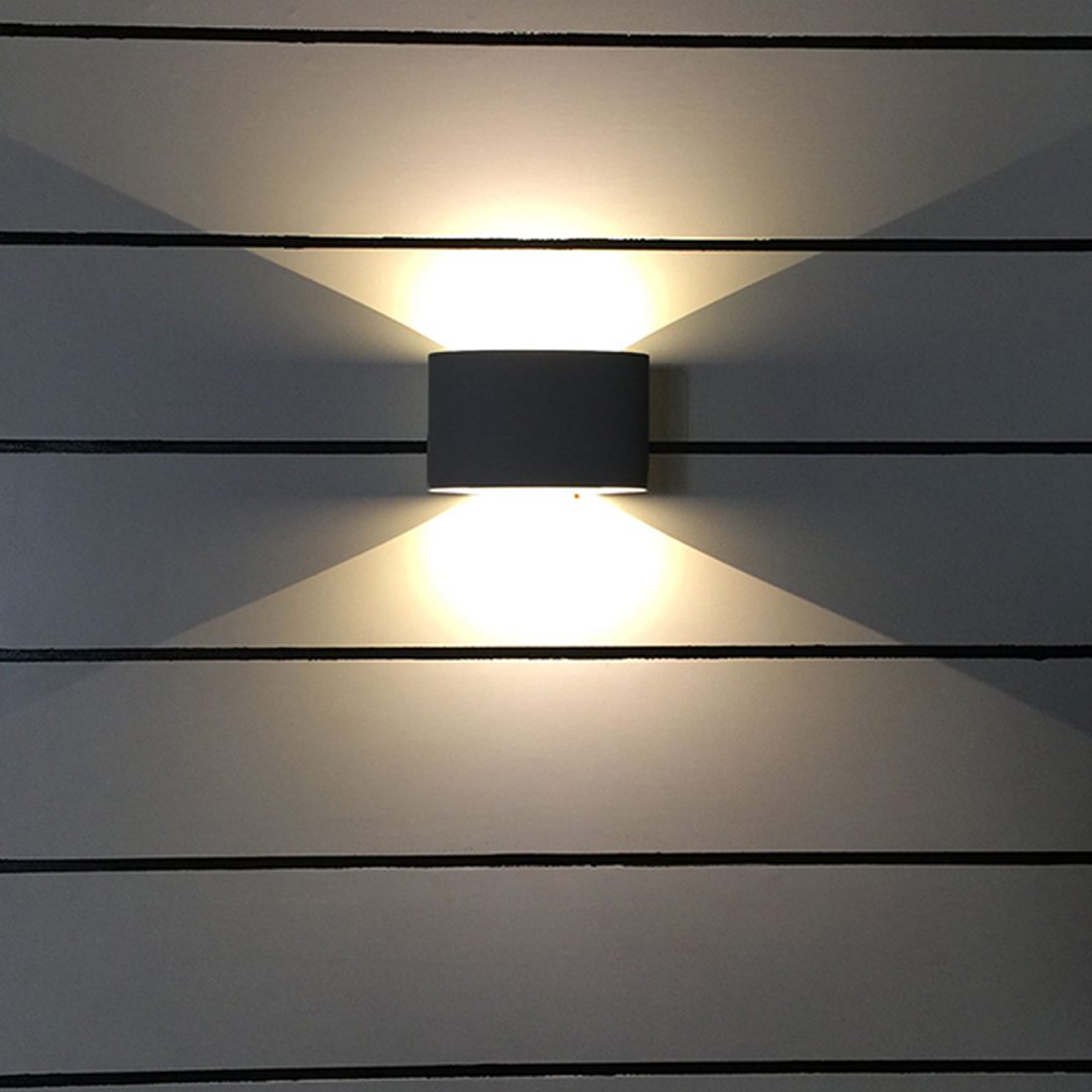 Outdoor up down wall light illuminating a brick wall with upward and downward beams.