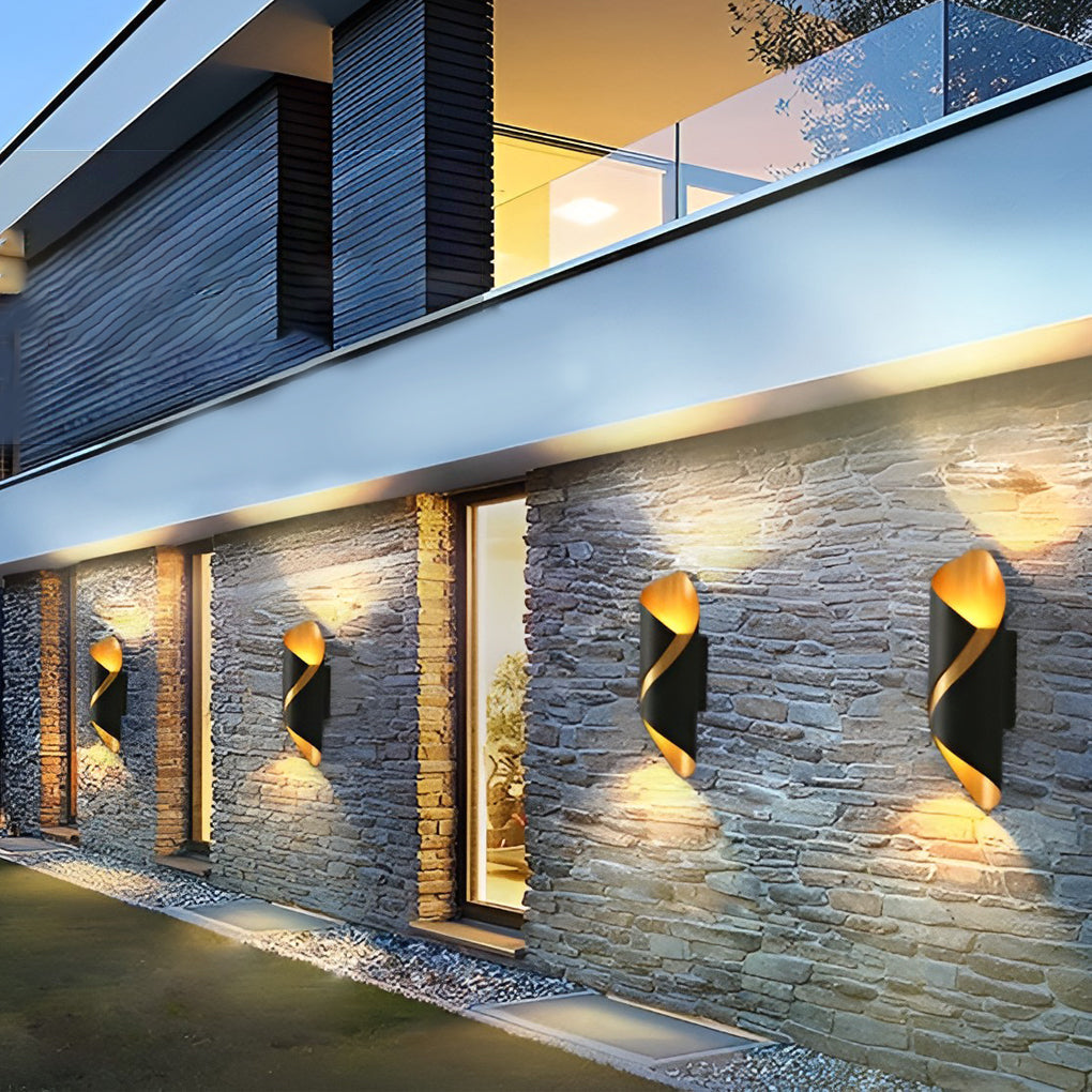 Outdoor up down wall light illuminating stone wall facade of contemporary building.