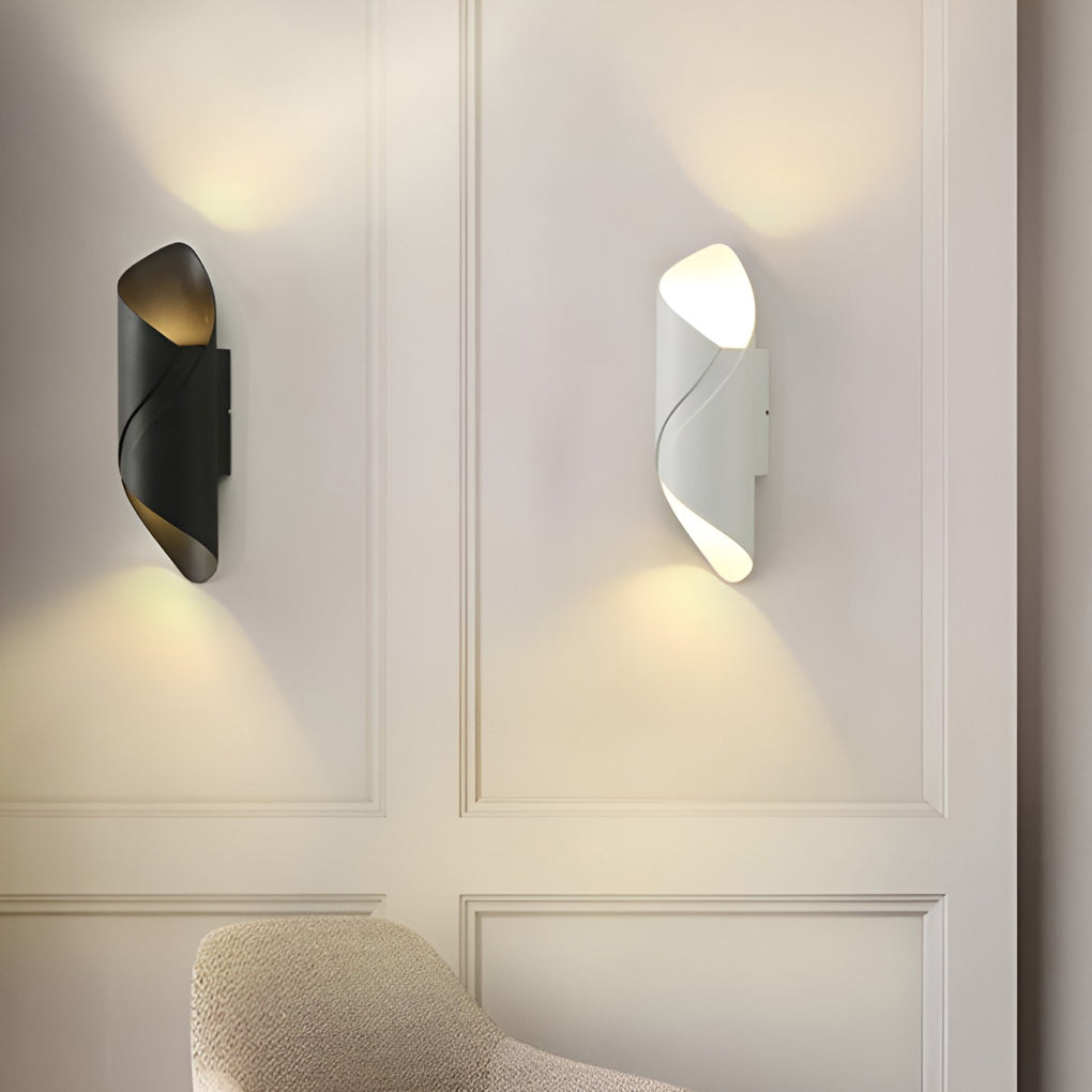 Outdoor up down wall light with white finish, mounted on white wall near sofa.