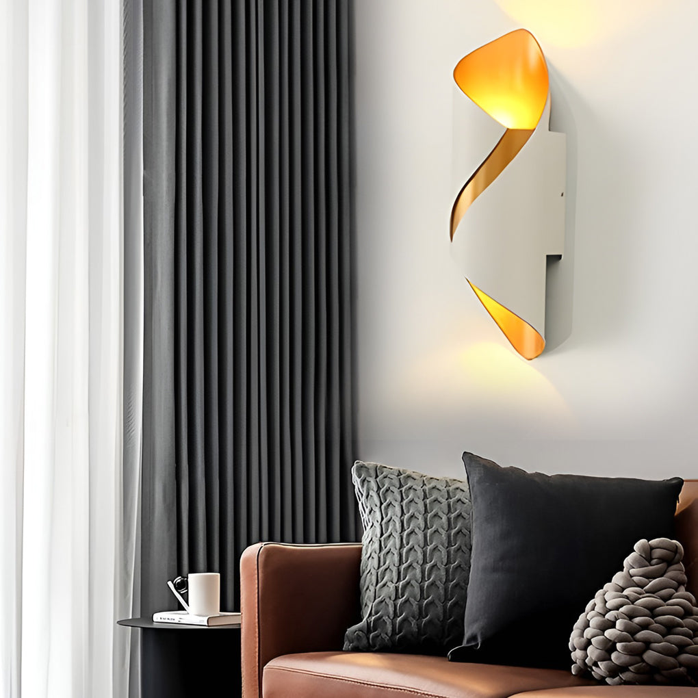 Outdoor up down wall light with white and gold finish, installed in cozy indoor setting.