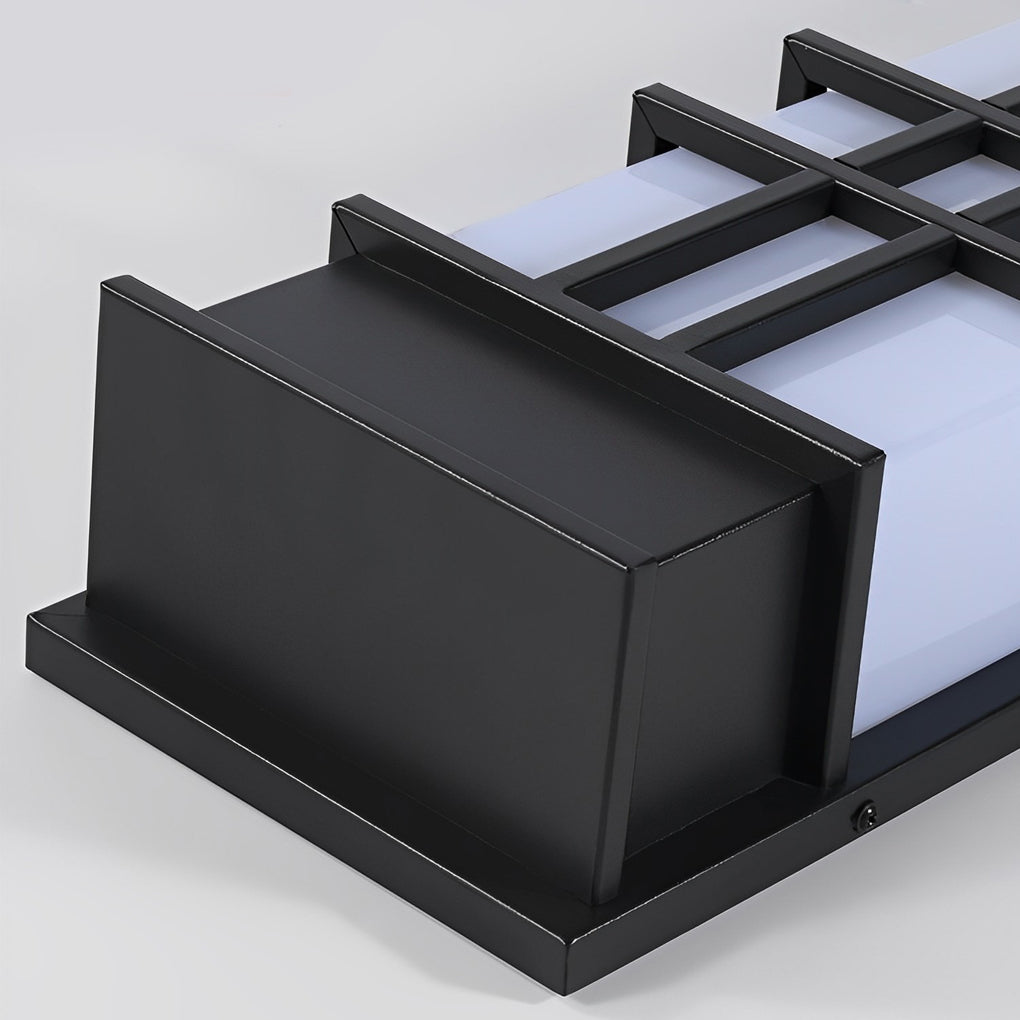 Outdoor wall sconce black with rectangular shape, providing soft illumination near a garden.