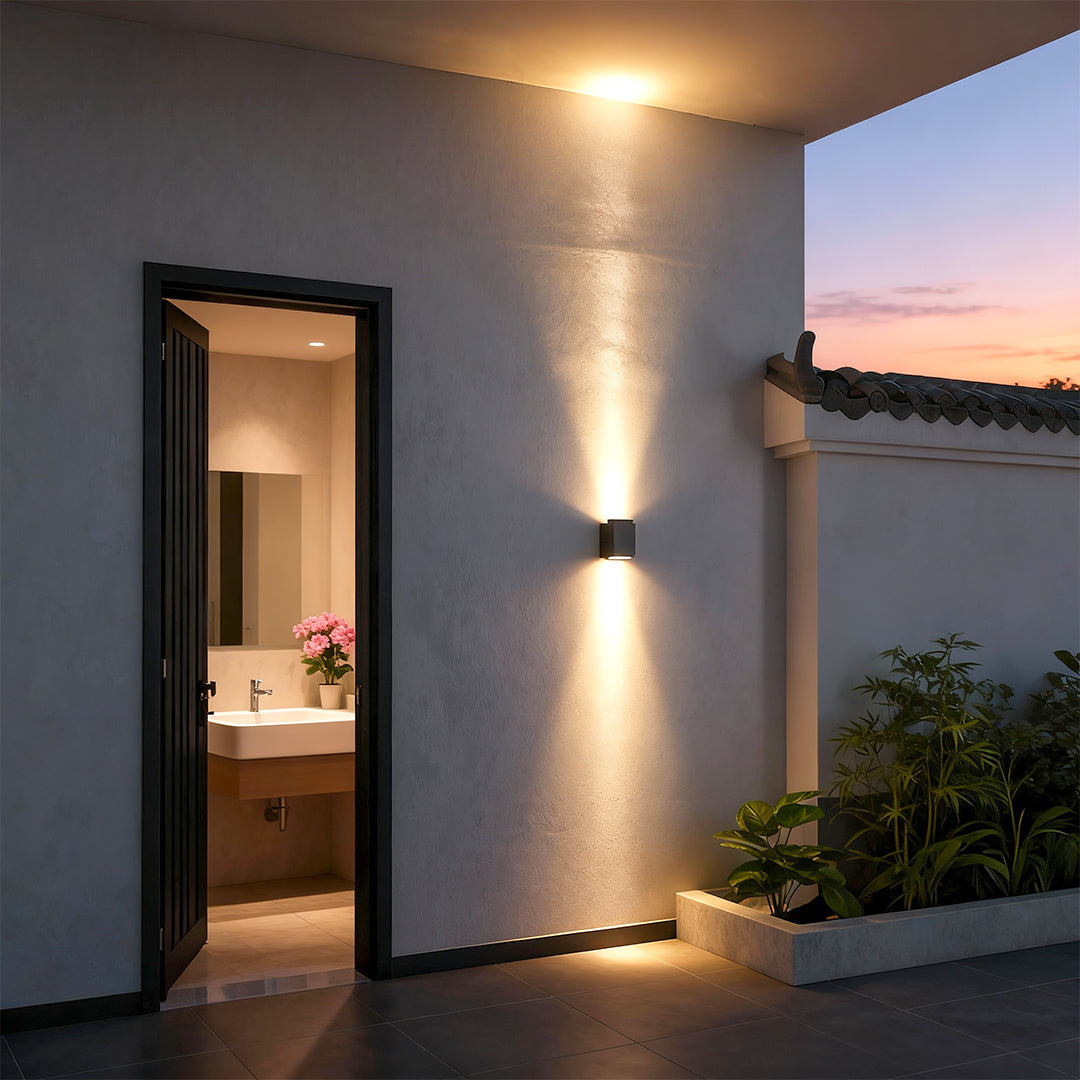 LED outdoor wall wash lights illuminating textured stone wall outdoors.
