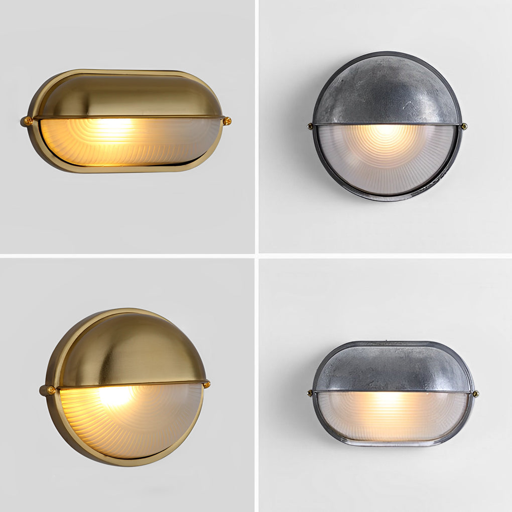 Close-up view of the metal housing edge of an oval bulkhead outdoor light fixture.