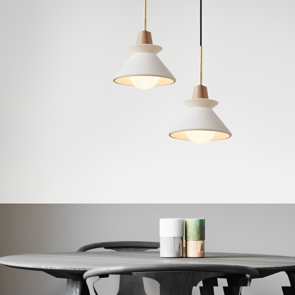Contemporary oval bulkhead wall light illuminating a textured exterior surface.