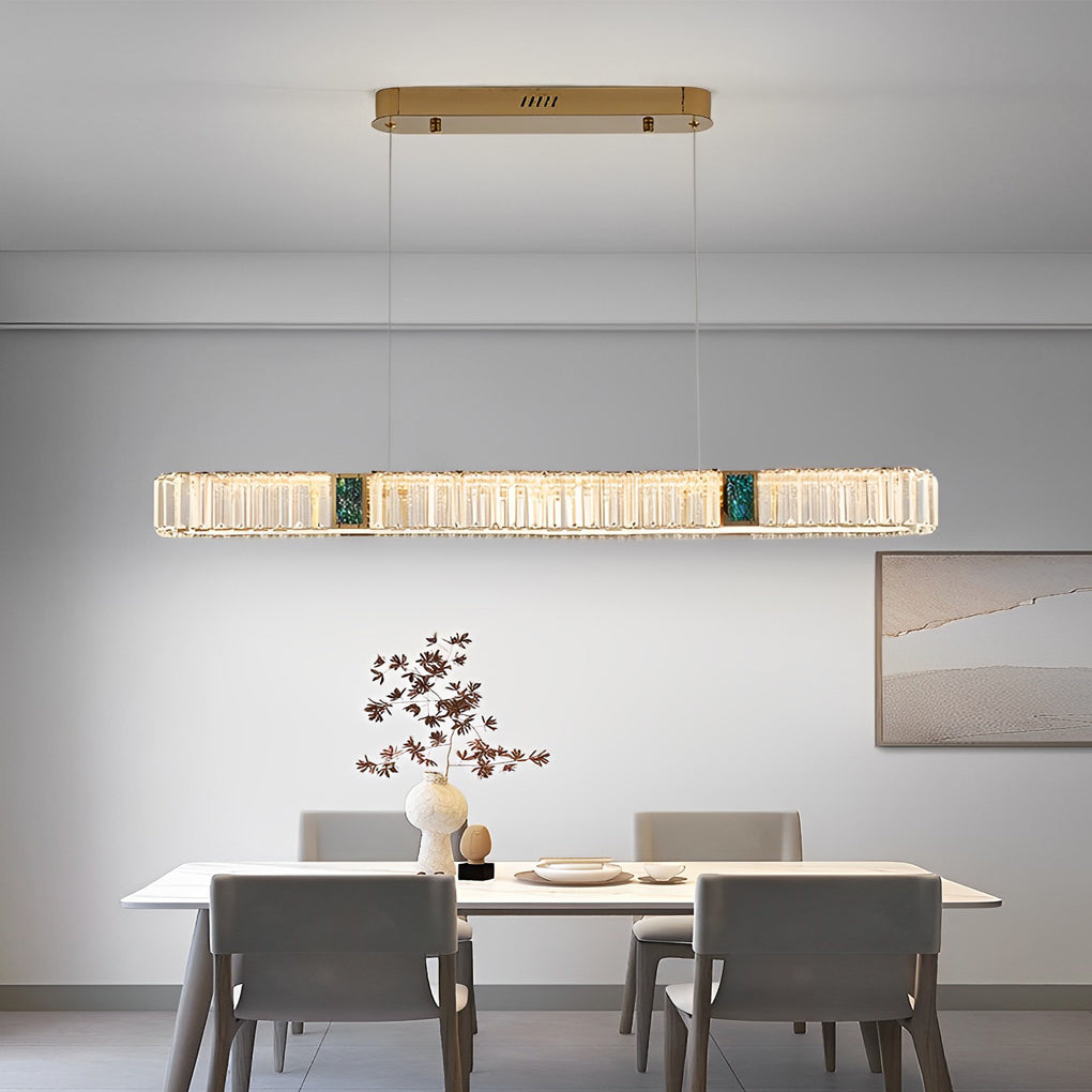 Oval crystal chandelier with a close-up of its crystal droplets and gold frame.