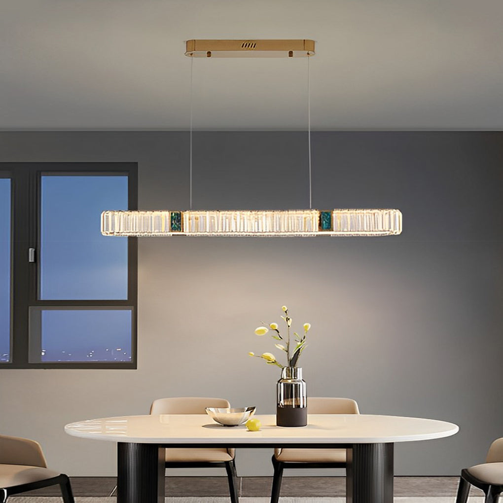 Oval crystal chandelier with a gold finish, providing warm light in a modern interior.