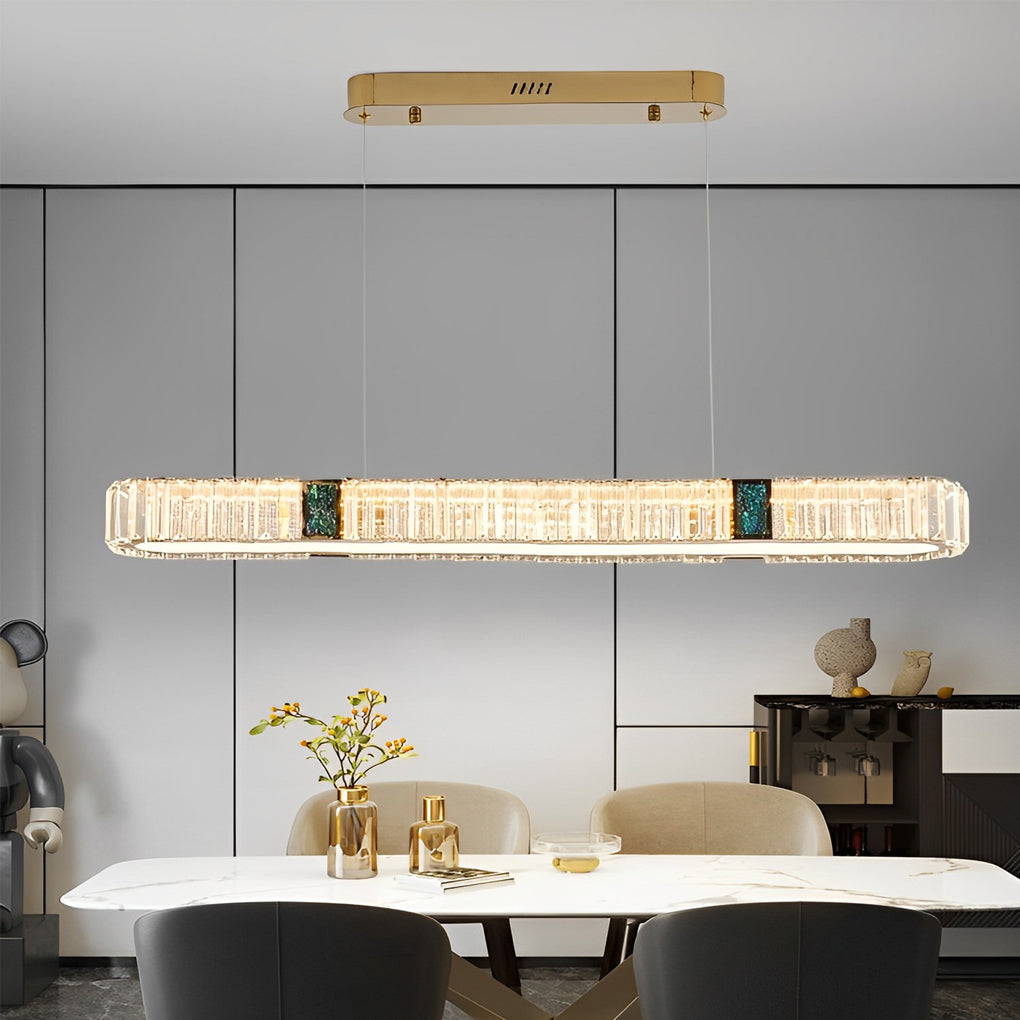 Oval crystal chandelier with a minimalist design, installed above a dining table.