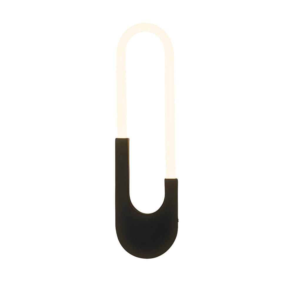 The warm glow of an oval LED wall sconce, creating a serene and stylish atmosphere in a modern bedroom.