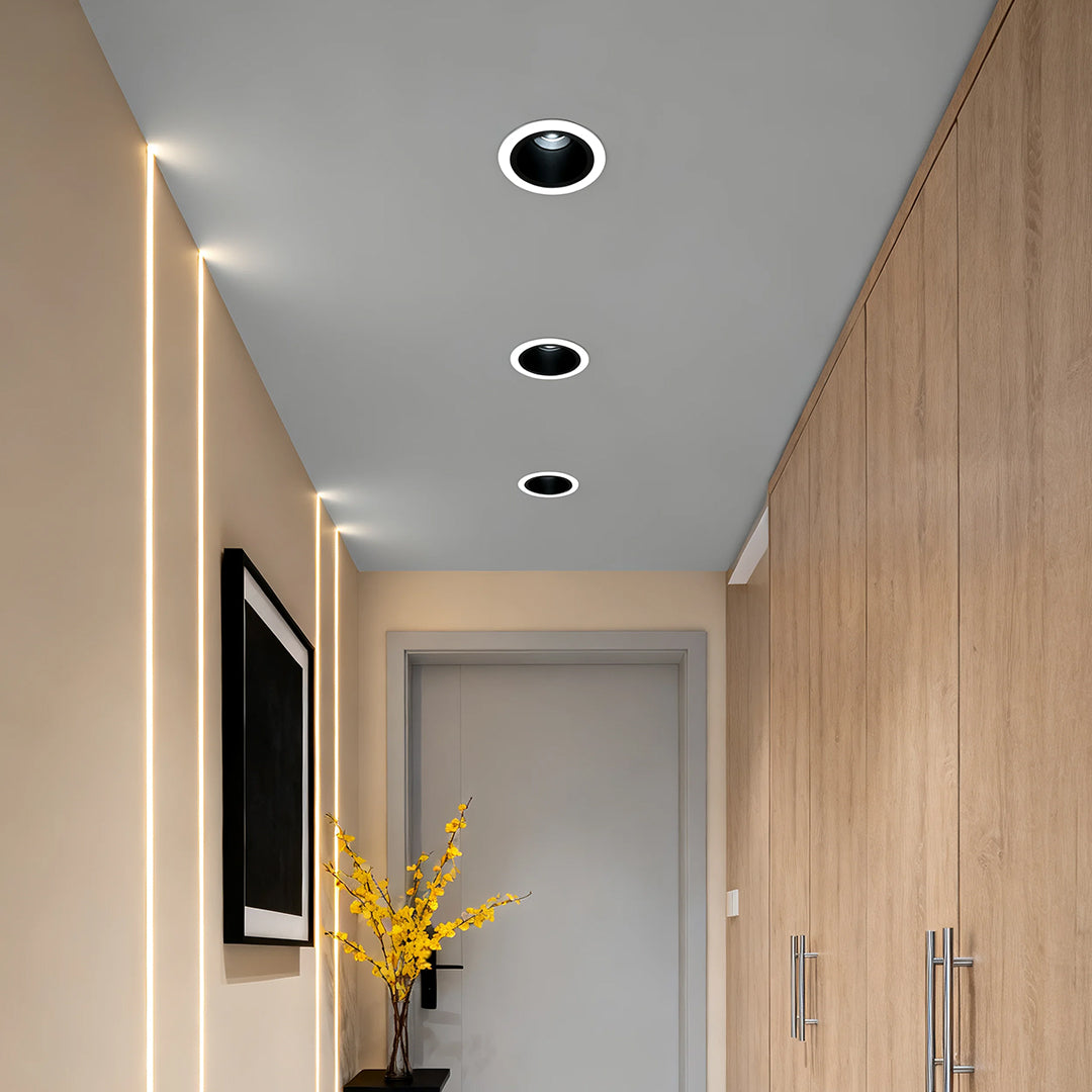 Pair of anti glare downlights brightening minimalist hallway with blonde wood and track lighting
