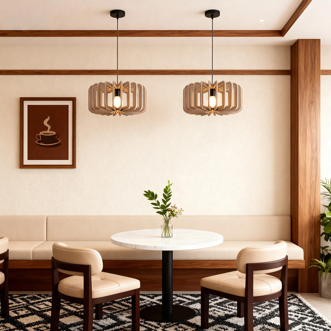 Pair of wooden slat Nordic pendant lights over a small round table in a cozy cafe setting.