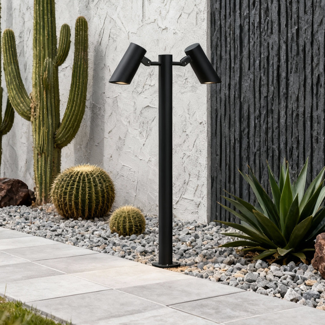 Outdoor garden scene illuminated by modern path lights led installed along stone walkway.