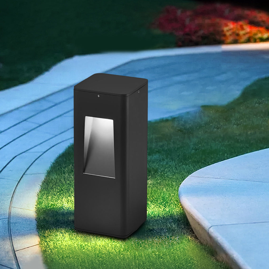Close-up of a pathway bollard light showcasing its sleek, rectangular design and warm light.