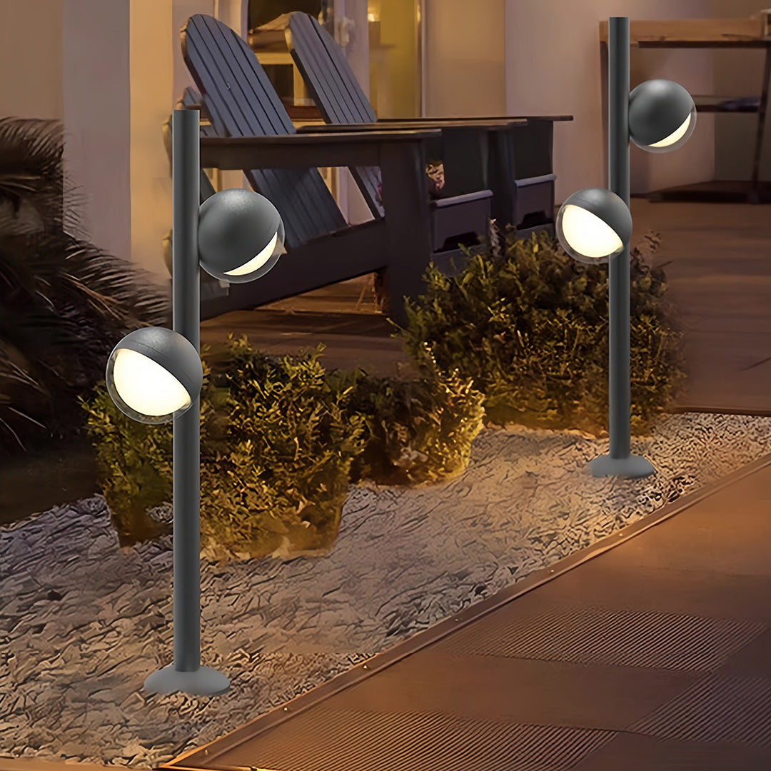 Pathway landscape lighting lining modern driveway approach with coordinated fixtures creating welcoming nighttime ambiance
