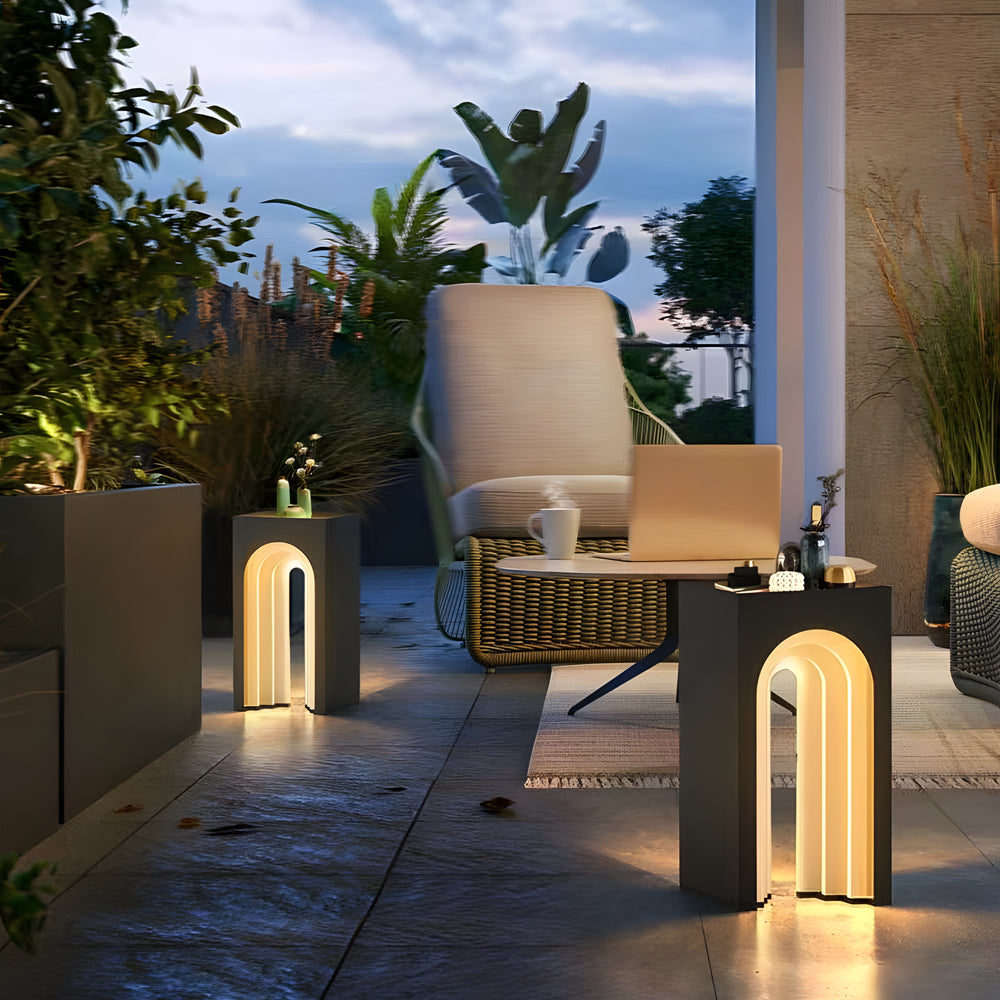 Garden pathway featuring multiple lighted lawn decorations with arched LED cutouts providing safe and stylish walkway illumination