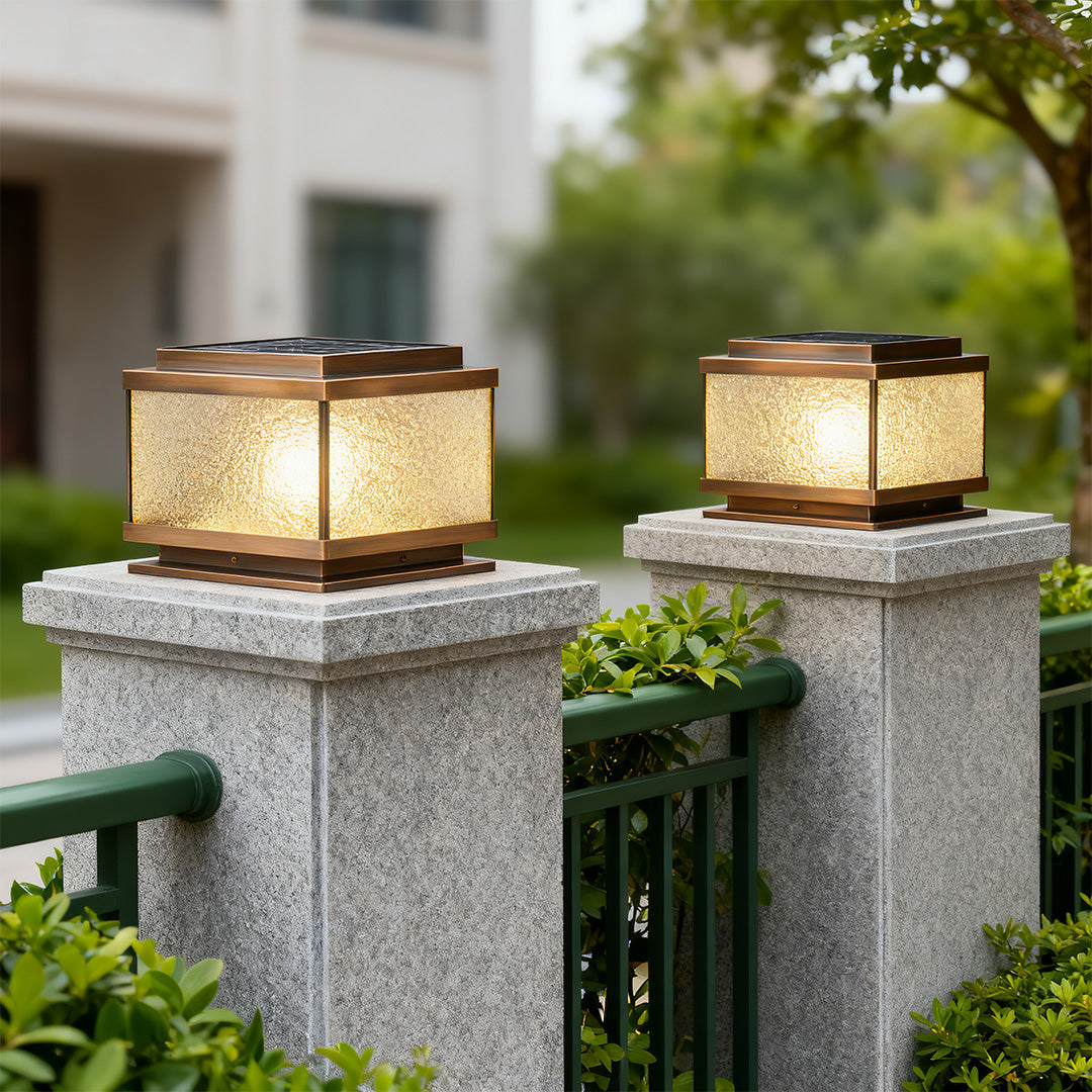 Garden pillar light on blue stone post with warm glow enhancing outdoor patio ambiance.