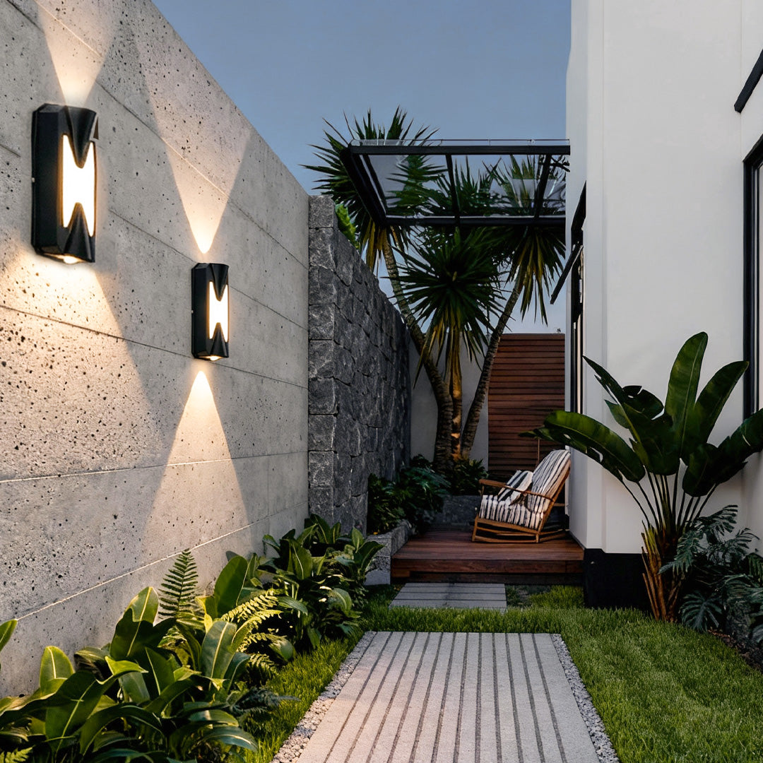 Up down outdoor wall light installed on a patio walkway wall, creating ambient exterior lighting.
