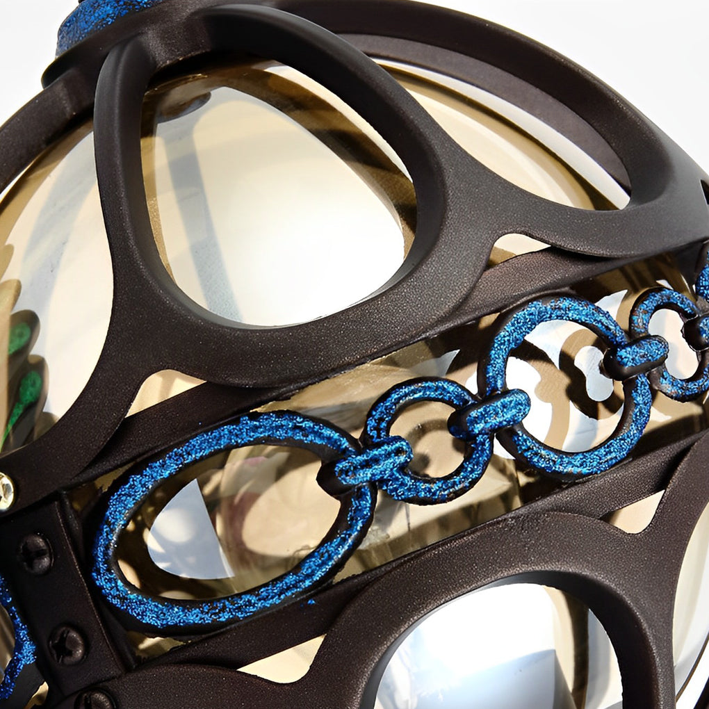 Close up of peacock wall light lantern shade with metal detailing.