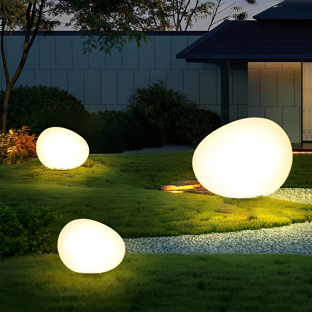 Pebble lights illuminating outdoor steps with ambient glow.