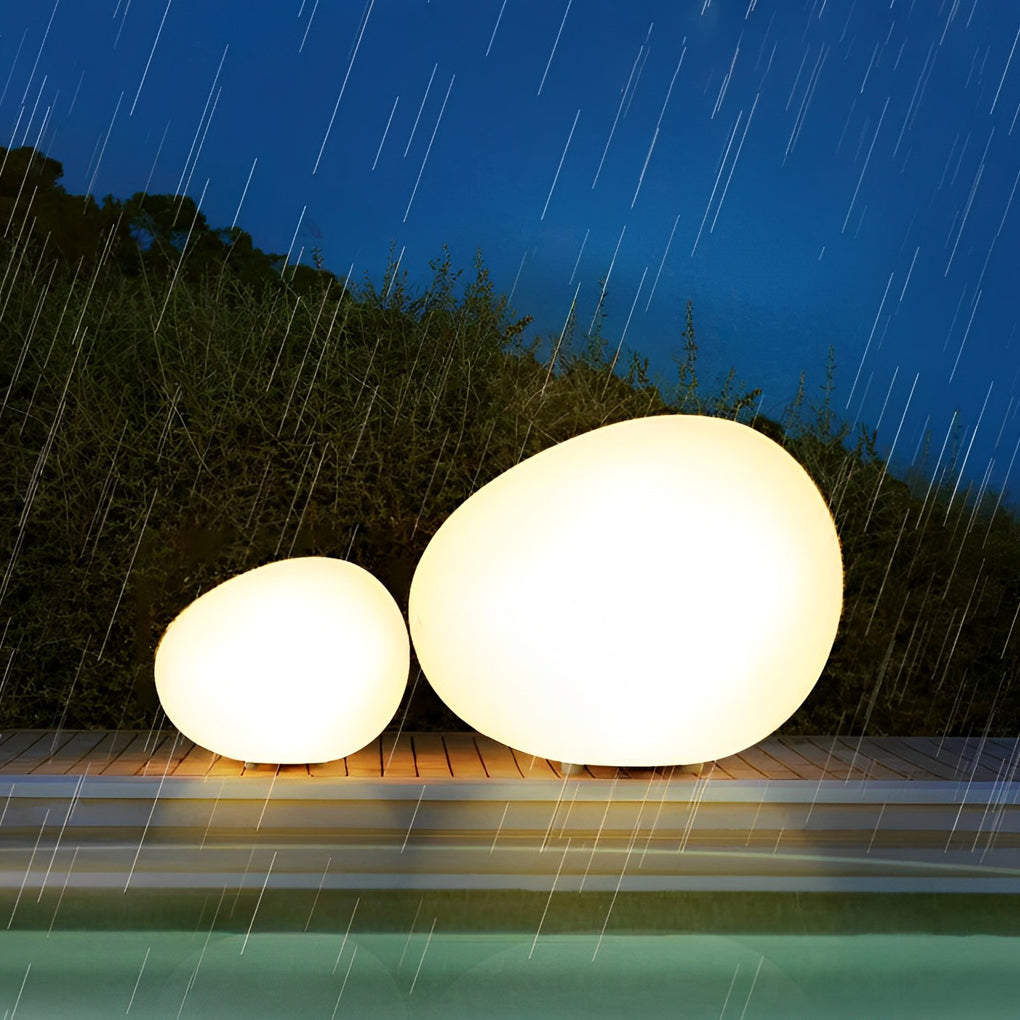 Pebble lights casting warm glow on outdoor terrace.