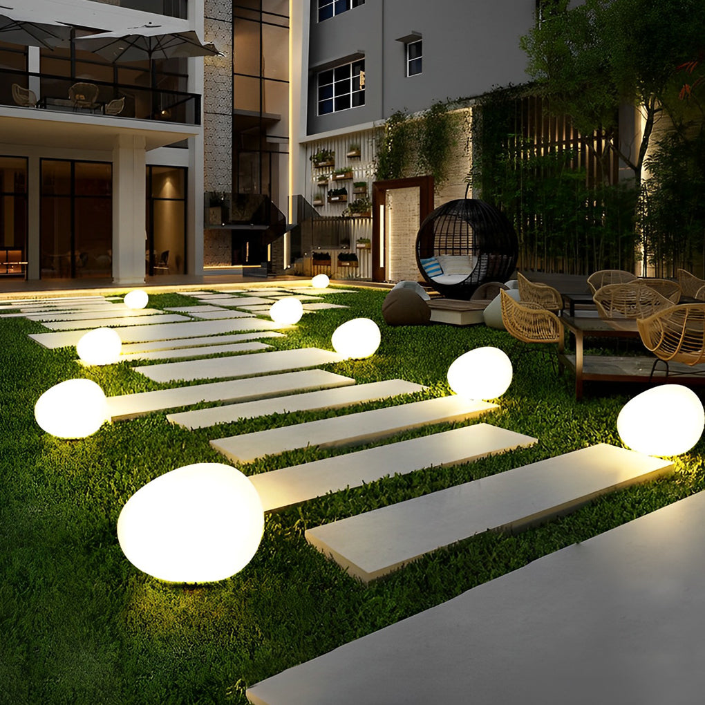 Pebble lights beside pool with modern outdoor seating area.
