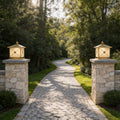 Elegant pillar light solar installed on stone entrance columns along a luxury garden pathway.