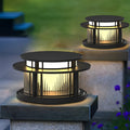 Pillar solar light installed on outdoor stone post providing warm pathway lighting.