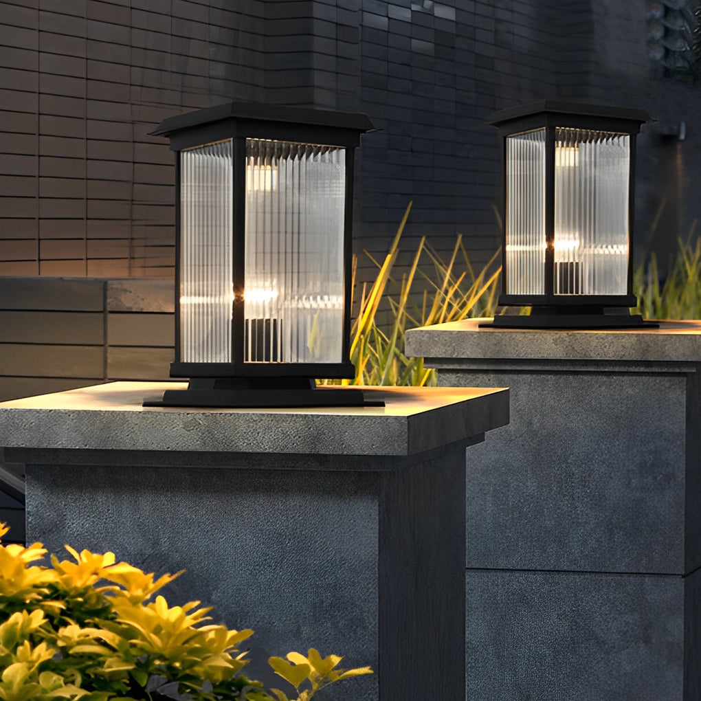 Pillar solar light mounted on a modern stone post, providing warm ambient illumination for an upscale outdoor landscape at night.