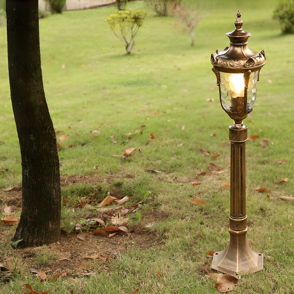 Poles for yard lights beside a tree, enhancing the landscape with vintage charm.