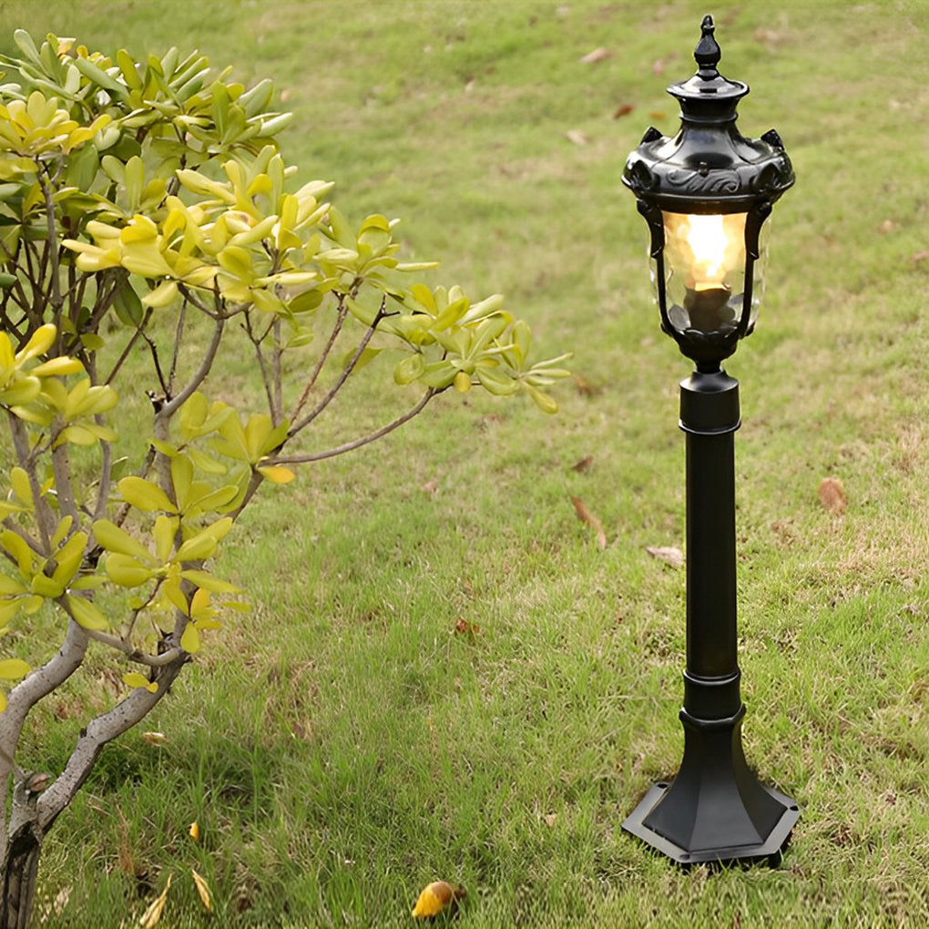 Poles for yard lights beside a wooden deck, providing directional lighting.